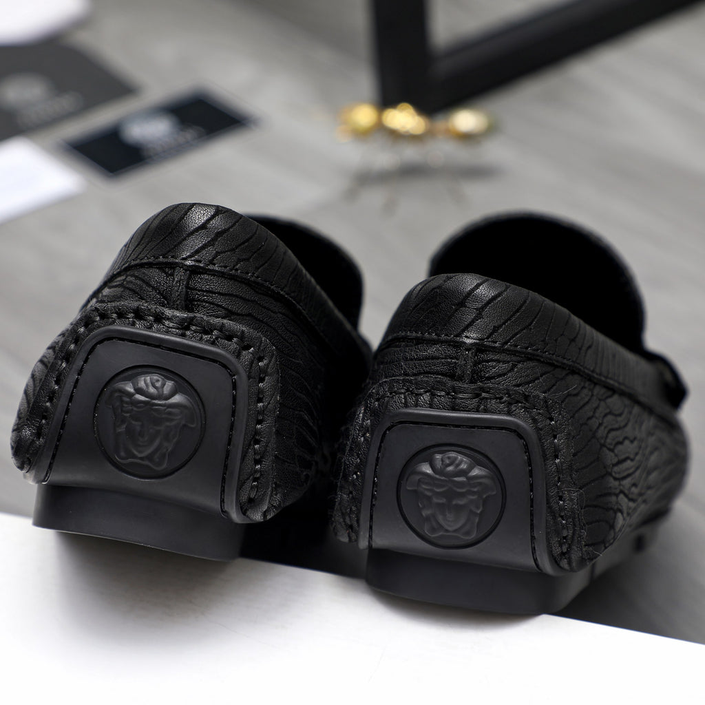 Versace luxury loafer, black outsole with logo emblem and textured grip