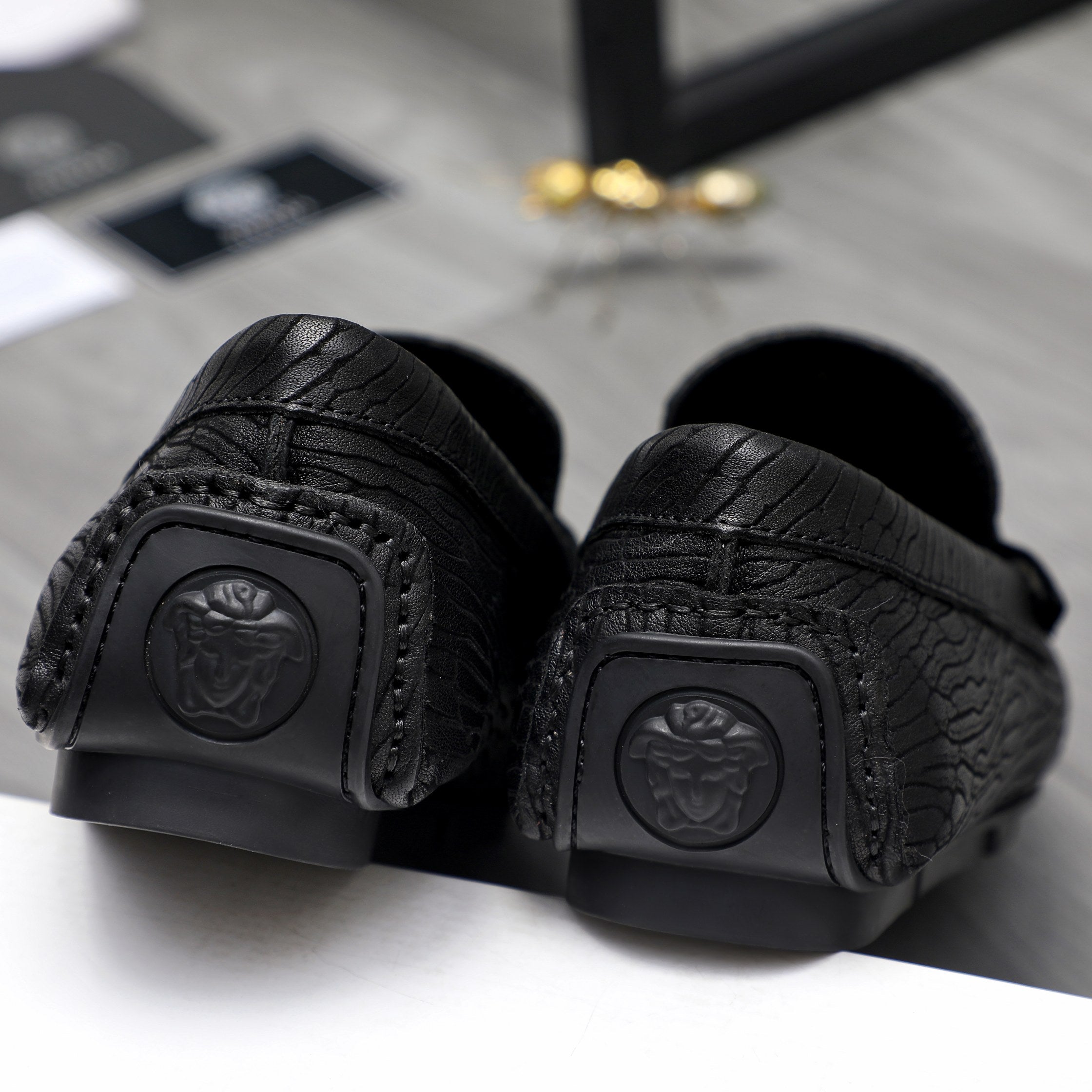 Versace luxury loafer, black outsole with logo emblem and textured grip