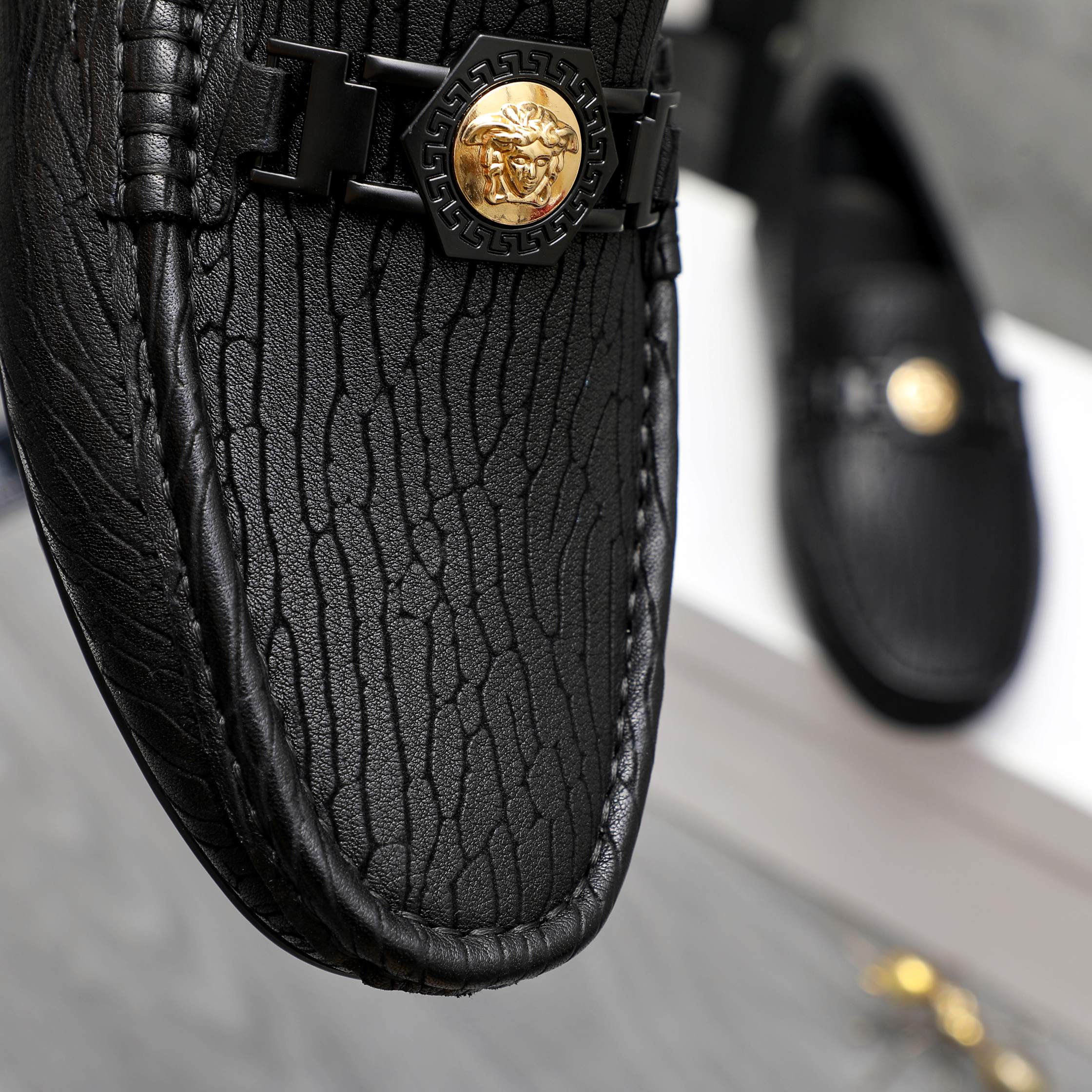 Versace luxury loafer, black embossed leather with gold logo buckle