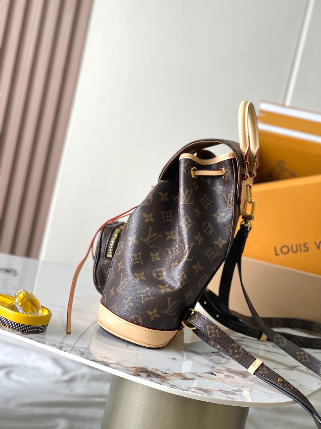 Monogram mini backpack with crossbody strap and gold-tone hardware