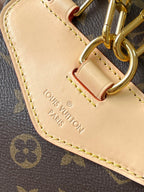 Beige leather strap loop with gold hardware and Louis Vuitton Paris stamped