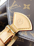 Beige leather trim detail with embossed logo and monogram canvas edge stitching