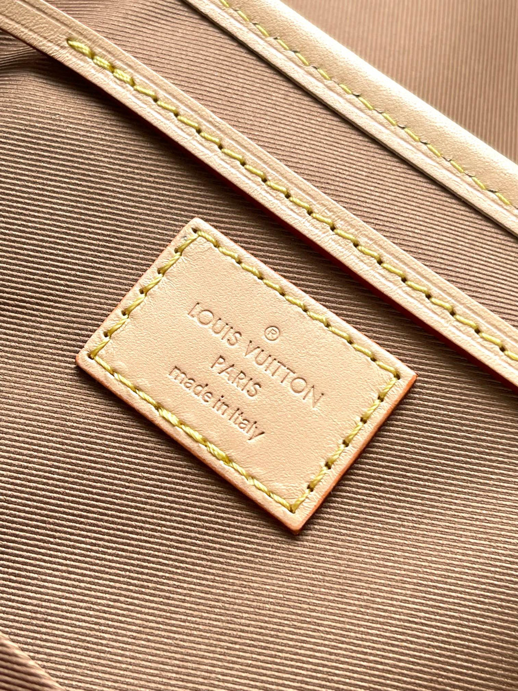 Beige interior label reading Louis Vuitton Paris and made in