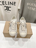 Luxury shoes by Golden Goose: light beige low-top sneakers, lace-up pair on shoe box