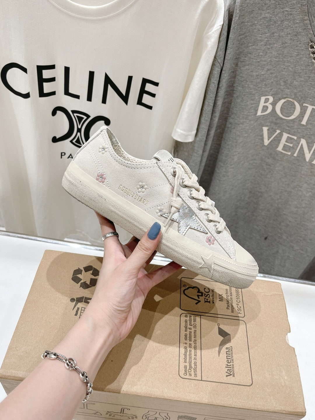 Luxury shoes by Golden Goose: light beige sneaker close-up with star side graphic