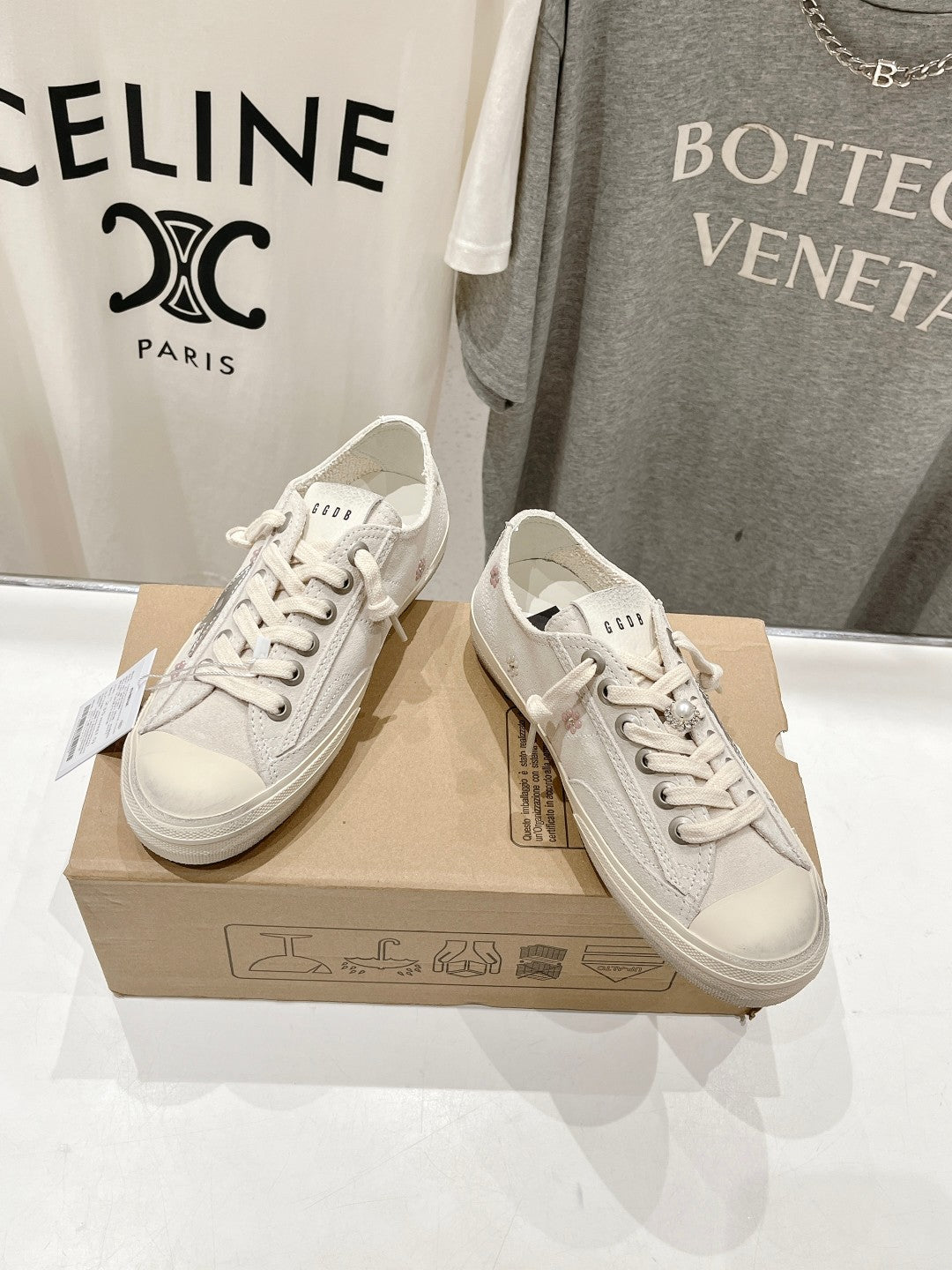 Luxury shoes by Golden Goose: light beige lace-up sneakers, side view pair on box