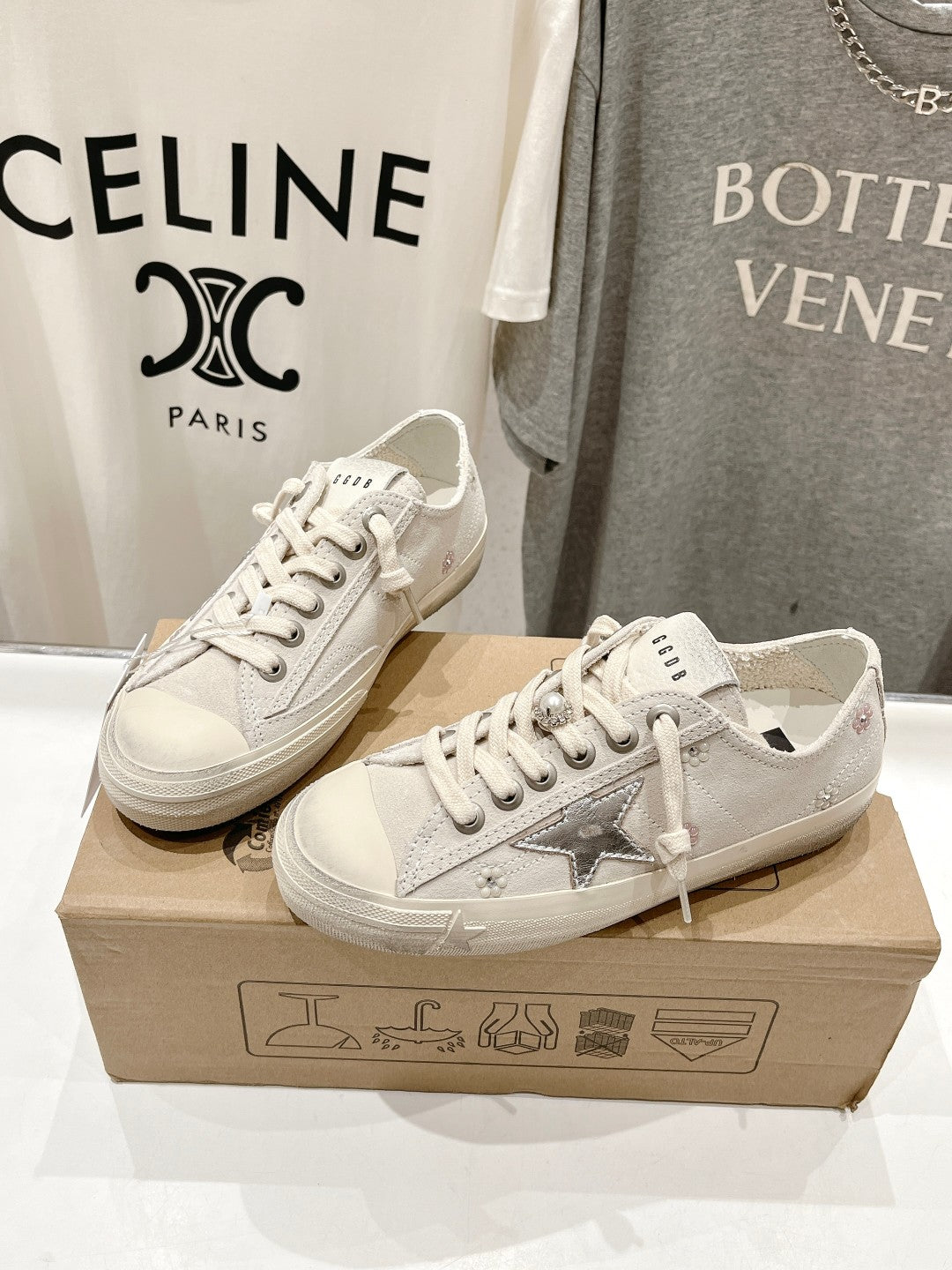 White lace-up sneakers with textured star applique on the side