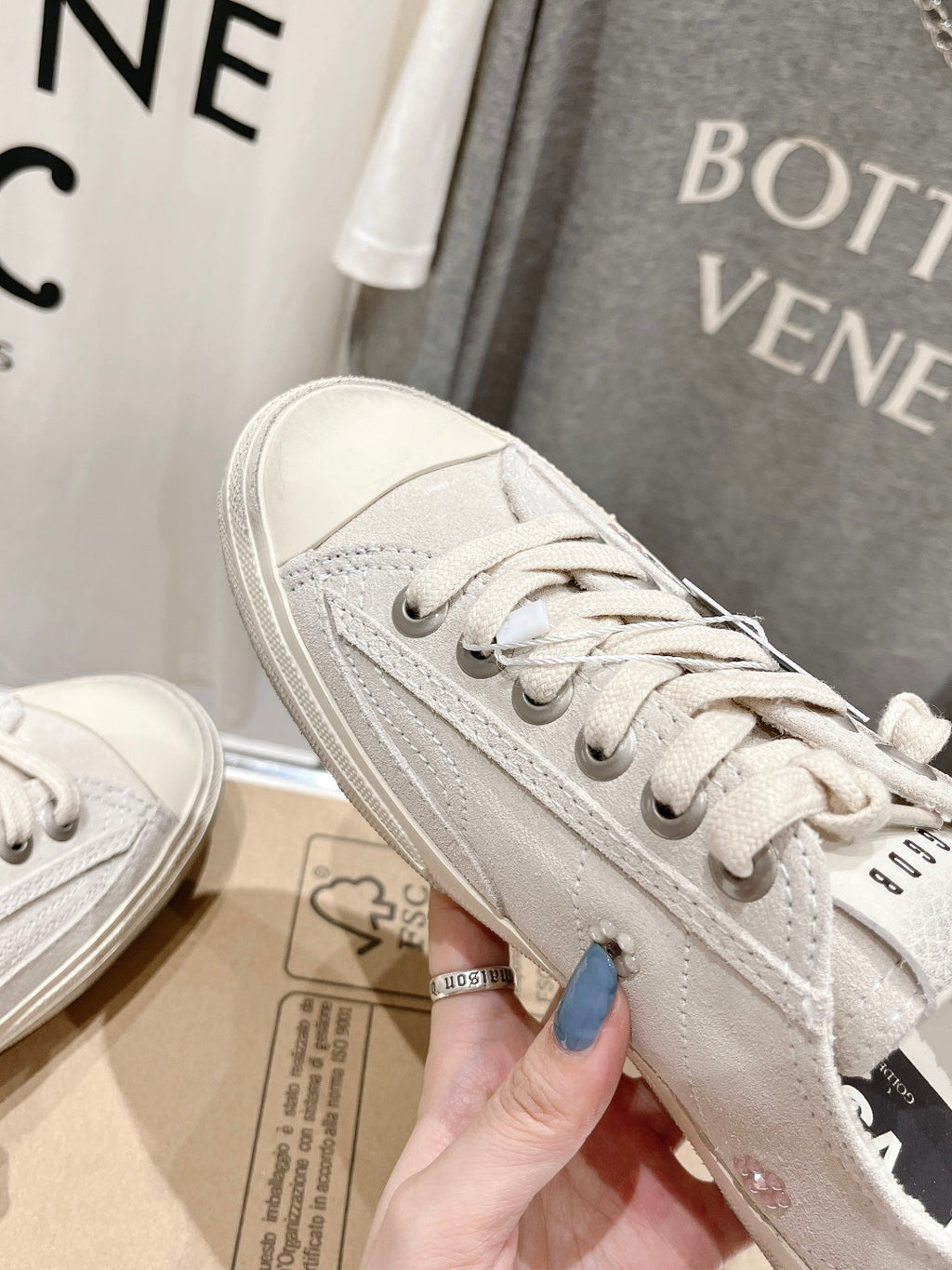 Luxury shoes by Golden Goose: light beige sneaker side profile with star graphic and laces