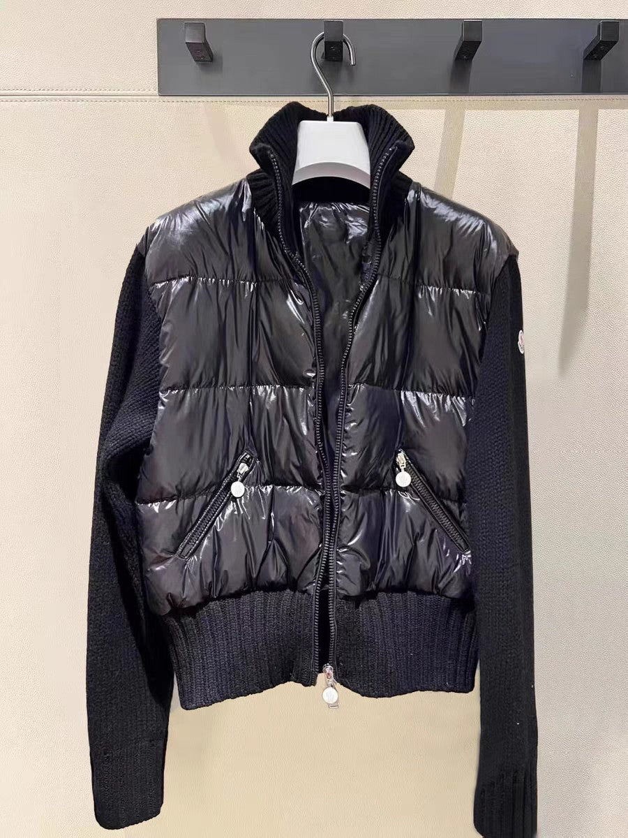 Moncler dark puffer jacket with knit sleeves, zip front, snap flap pockets.