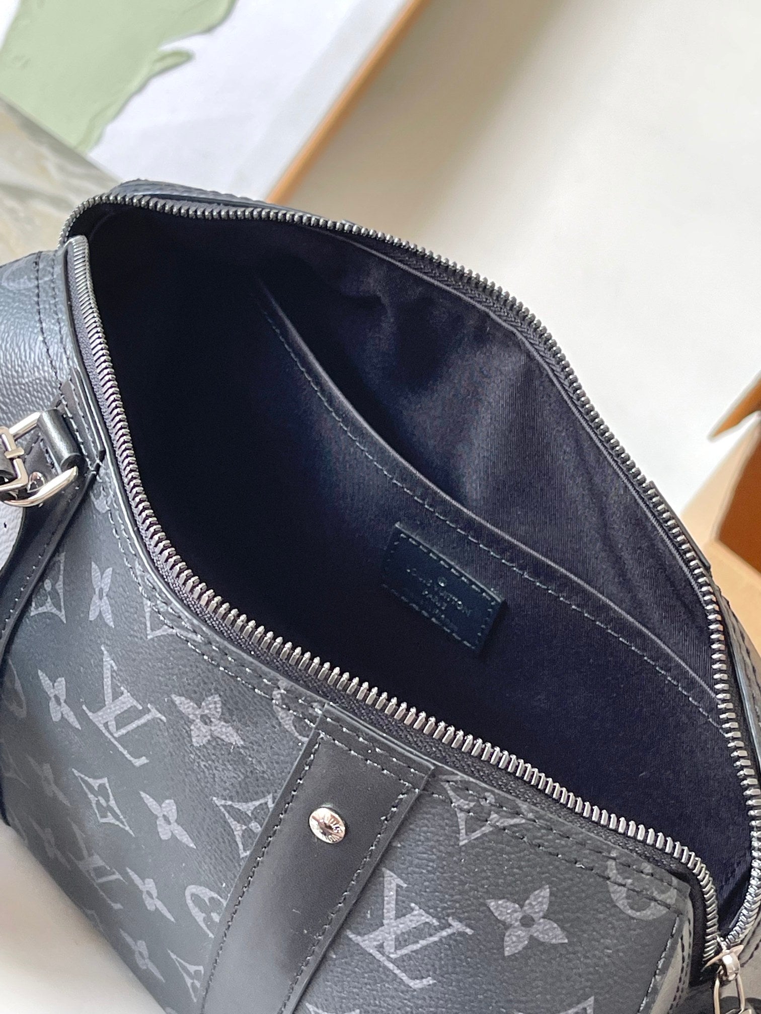 Louis Vuitton monogram bag interior with dark fabric lining and zipper track