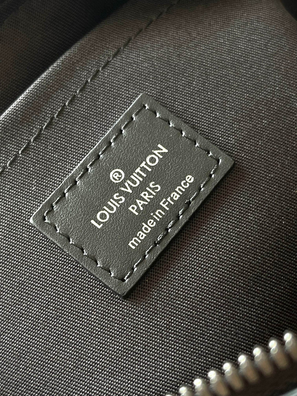 Louis Vuitton brand patch reading 'Louis Vuitton Paris' and 'made in France'