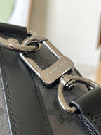 Louis Vuitton handbag close-up of silver-tone clasp and metal strap hardware
