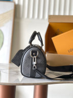 Louis Vuitton monogram mini handbag with top handle and black crossbody strap