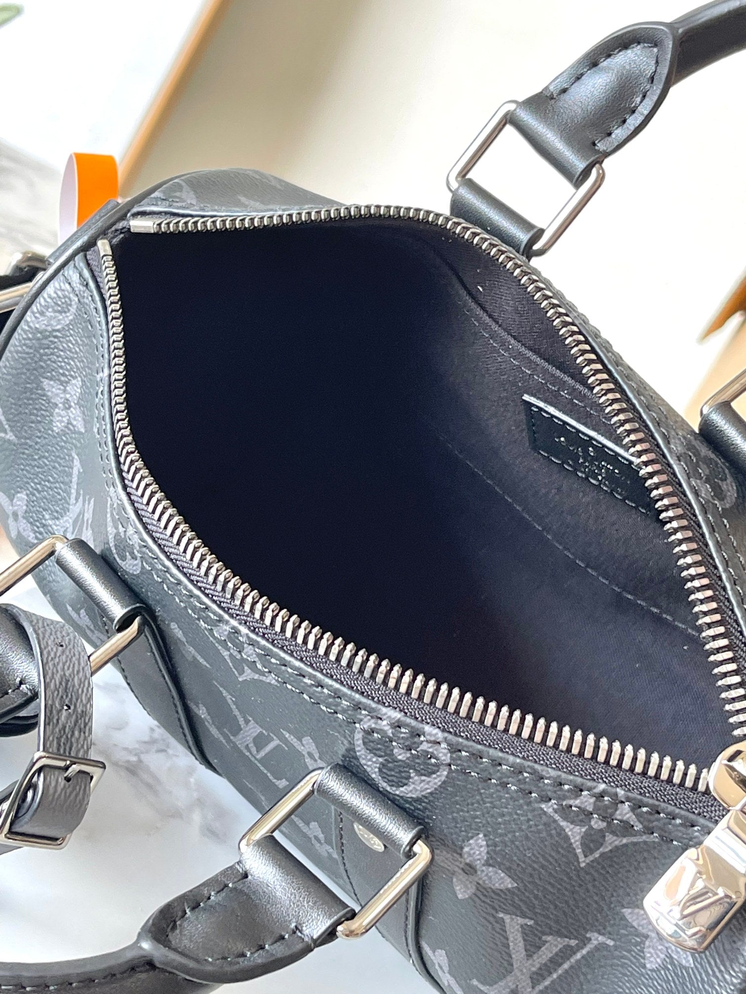 Louis Vuitton monogram crossbody bag with open interior and zipper closure