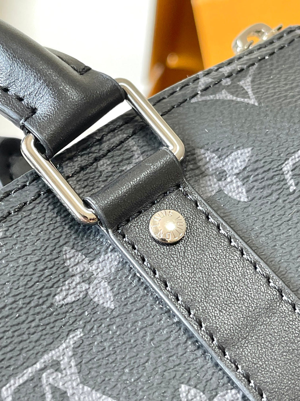 Louis Vuitton monogram bag strap attachment with metal ring and button hardware