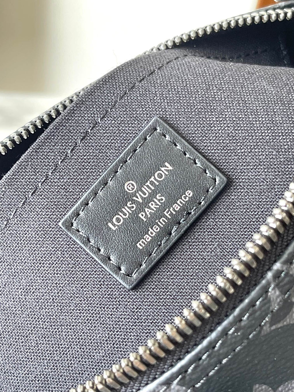 Louis Vuitton Paris leather label patch on monogram bag near zipper pull