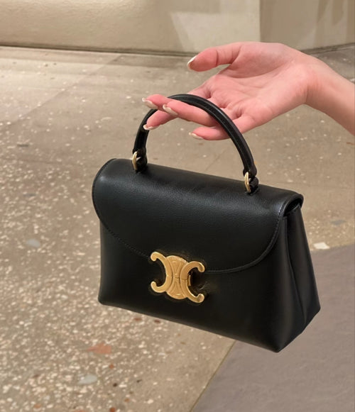 Celine black mini bag with top handles and gold logo on front flap