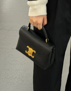 Celine black structured mini bag with gold logo front flap and top handle