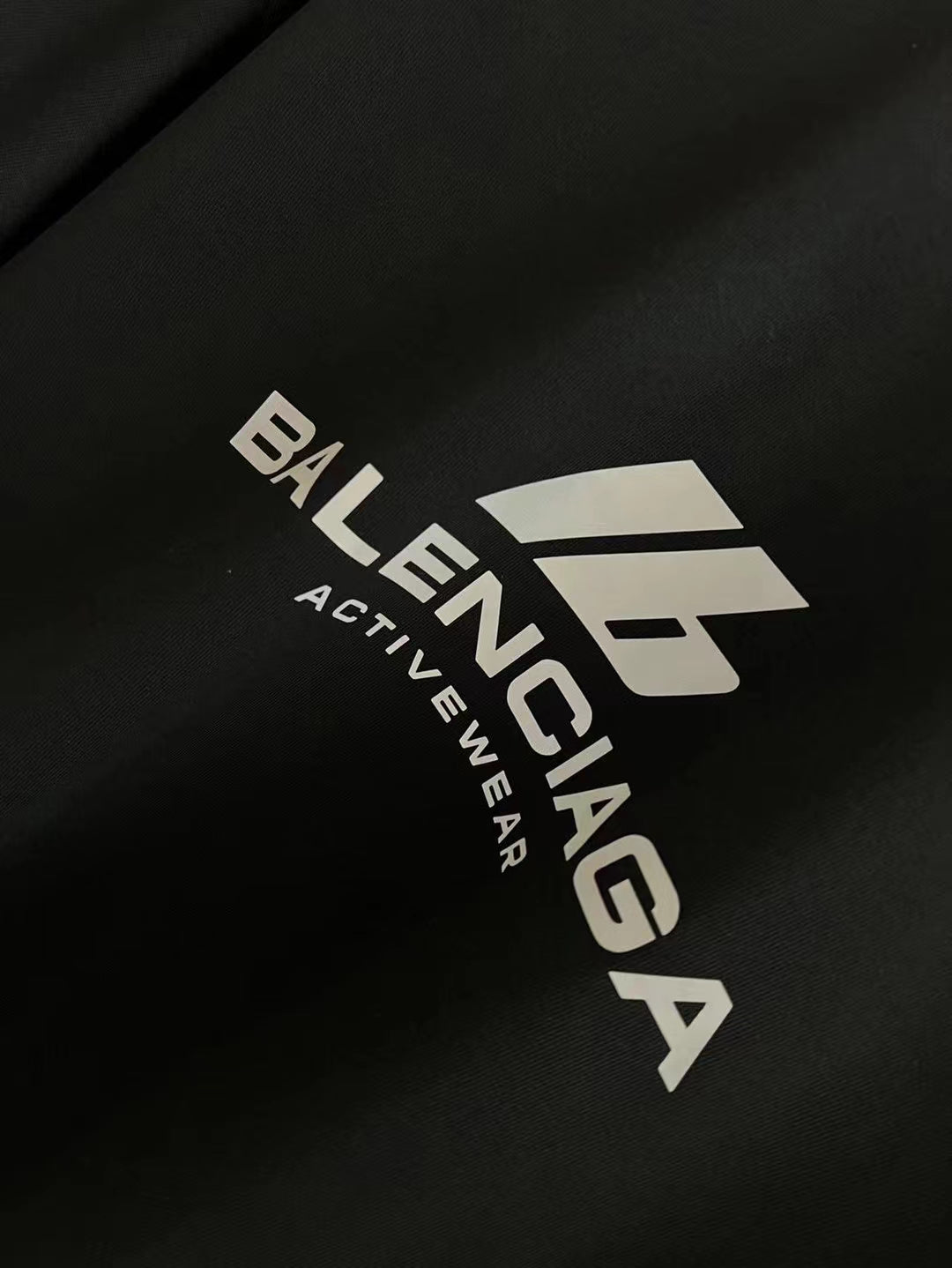 Black T-shirt close-up with Balenciaga Activewear logo print