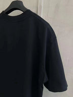 Black T-shirt with crew neck and short sleeves, side view