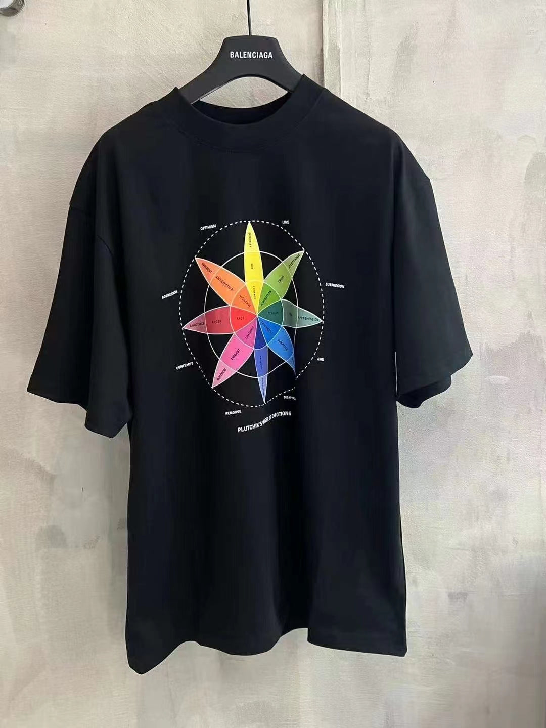 Black T-shirt with colorful wheel graphic on chest