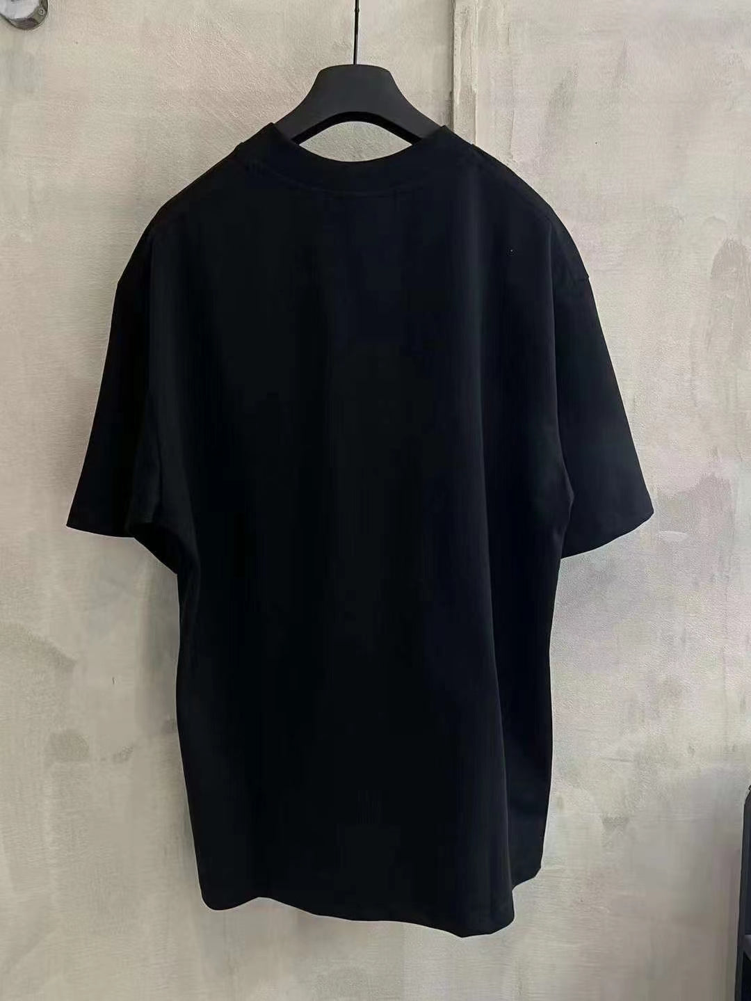 Black crewneck T-shirt with short sleeves and straight hem
