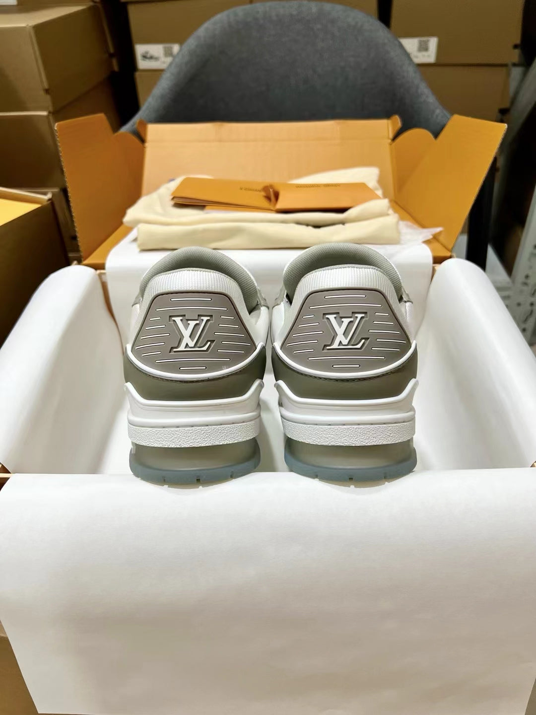 Louis Vuitton trainer sneakers, back view showing gray heel tops with LV embossed logos