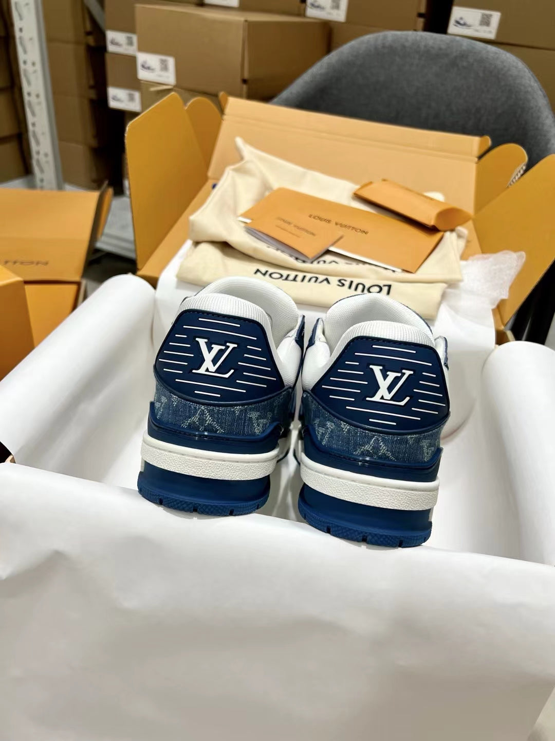 Louis Vuitton trainer shoes, back view with navy heels and LV logos