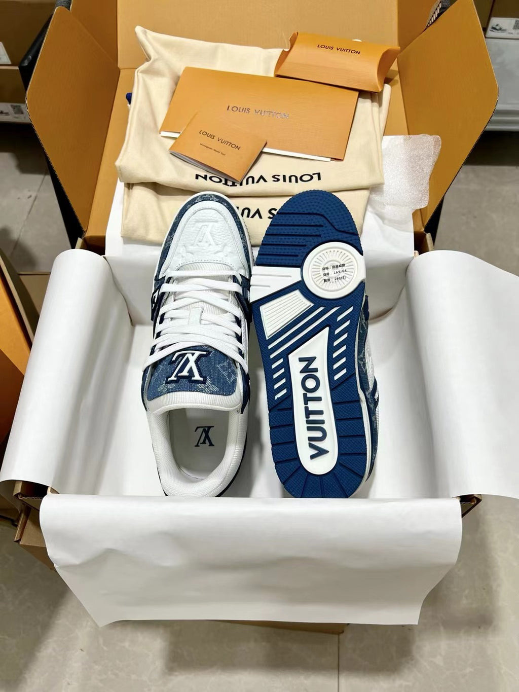 Louis Vuitton trainer shoes, box view with white lace front and navy side