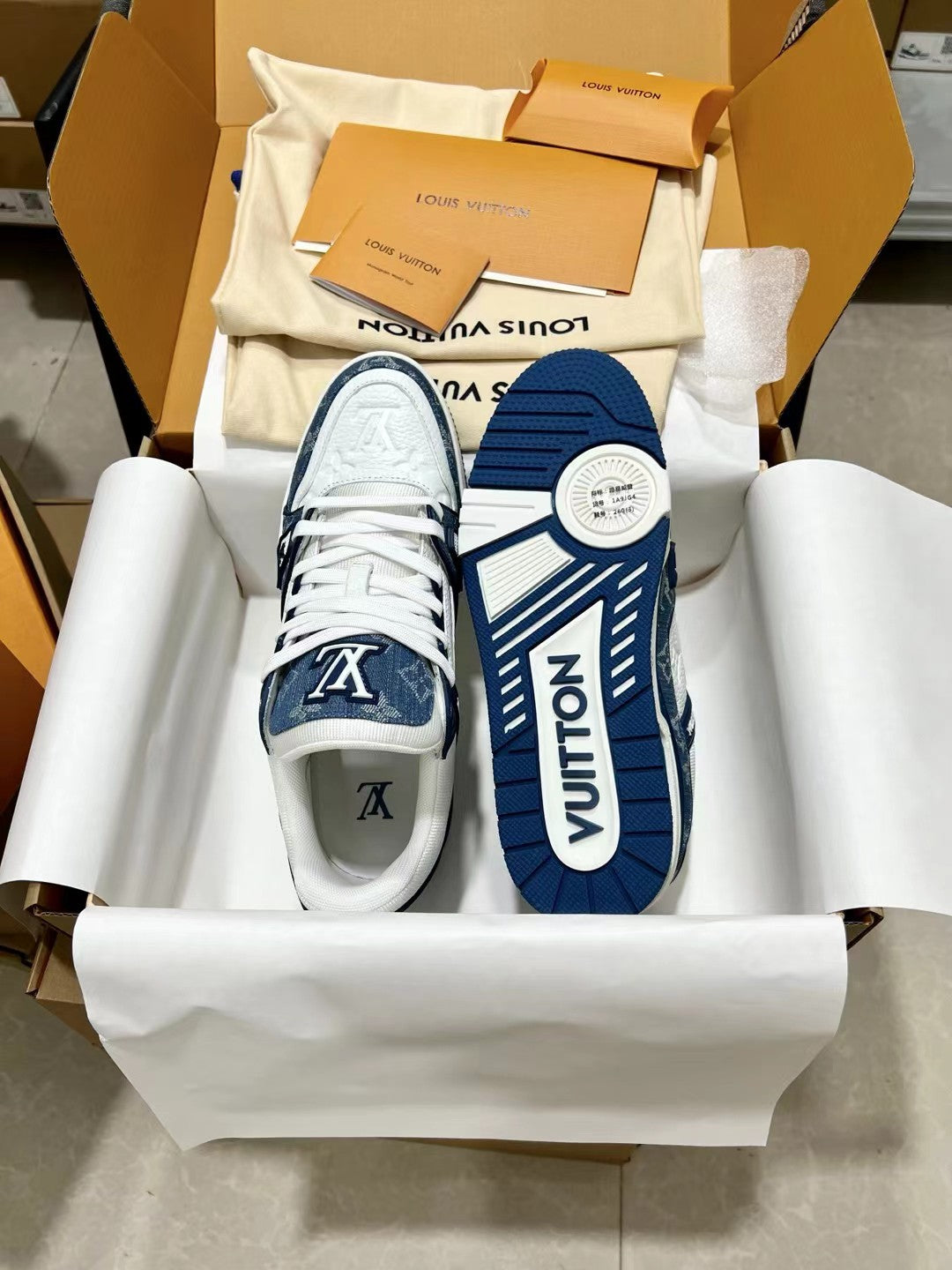 Louis Vuitton trainer shoes, box view with white lace front and navy side