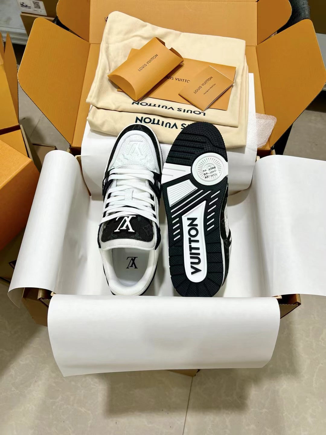 Low-top trainer sneakers in box, white and black with LV logo on heel and tongue