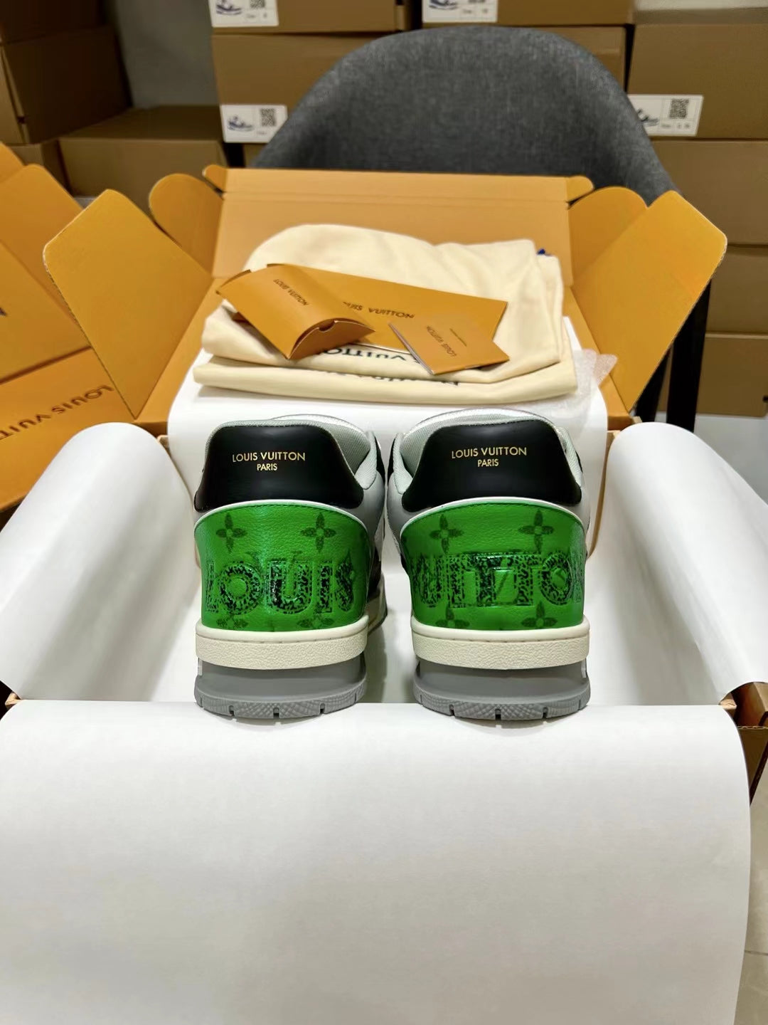 Louis Vuitton trainer sneakers, rear view with green heel panels and white sole