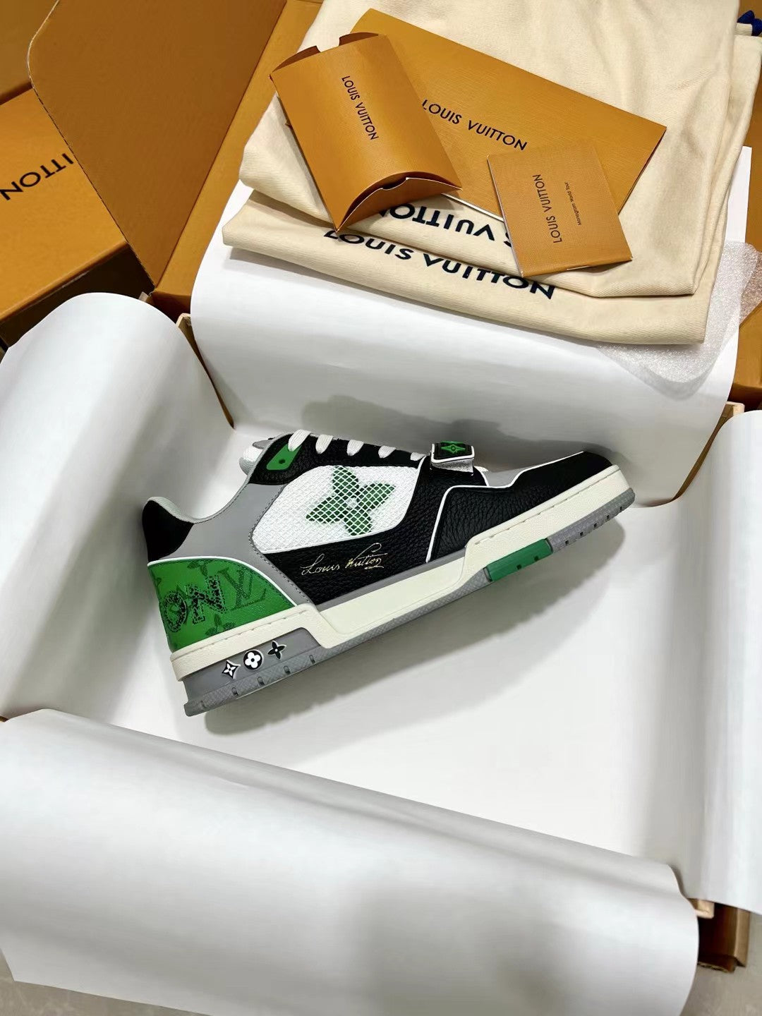 Louis Vuitton trainer sneaker, black white with green trim and logo patch on side