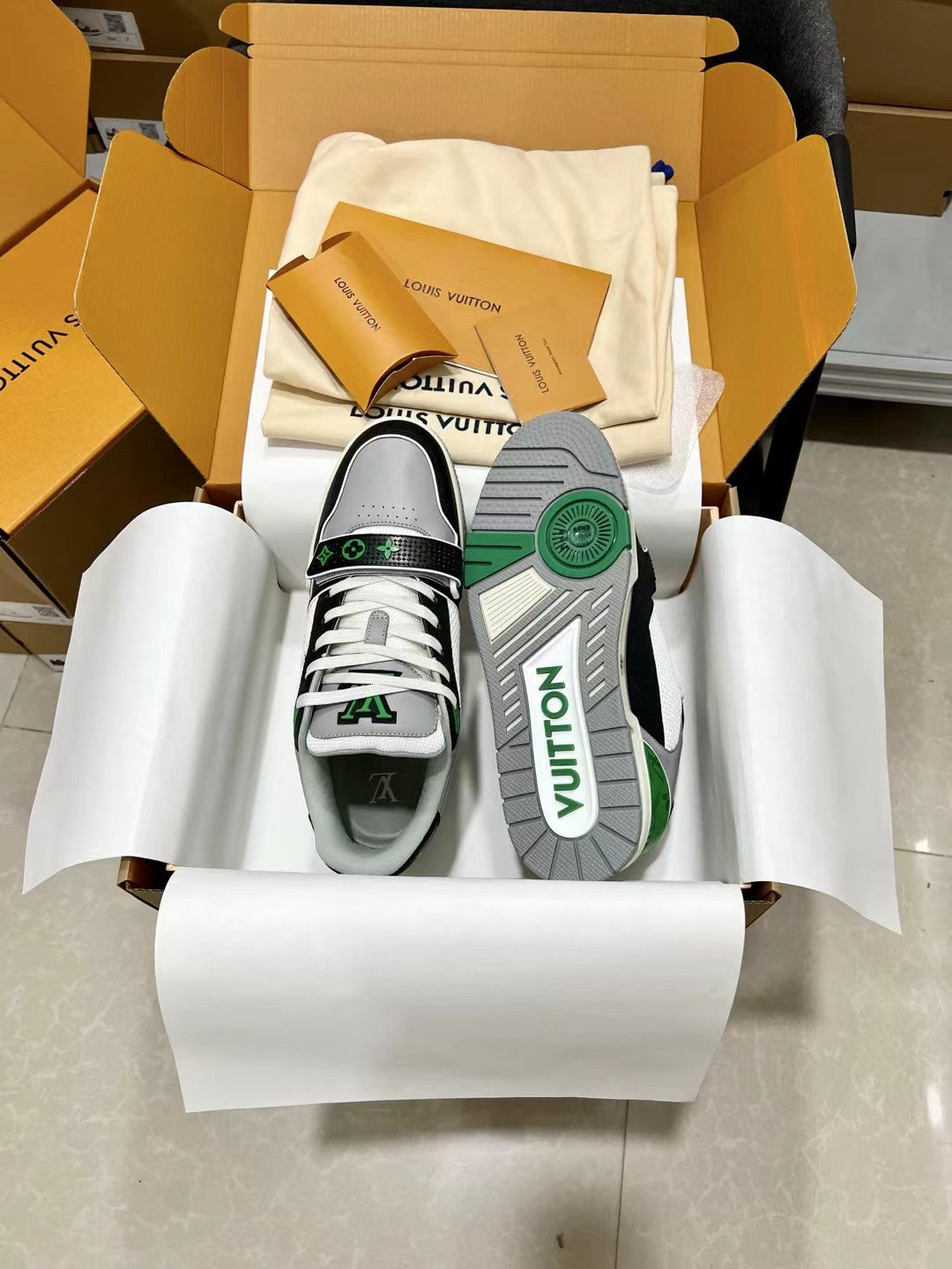 Louis Vuitton trainer sneakers, white laces with green logo print on side and sole