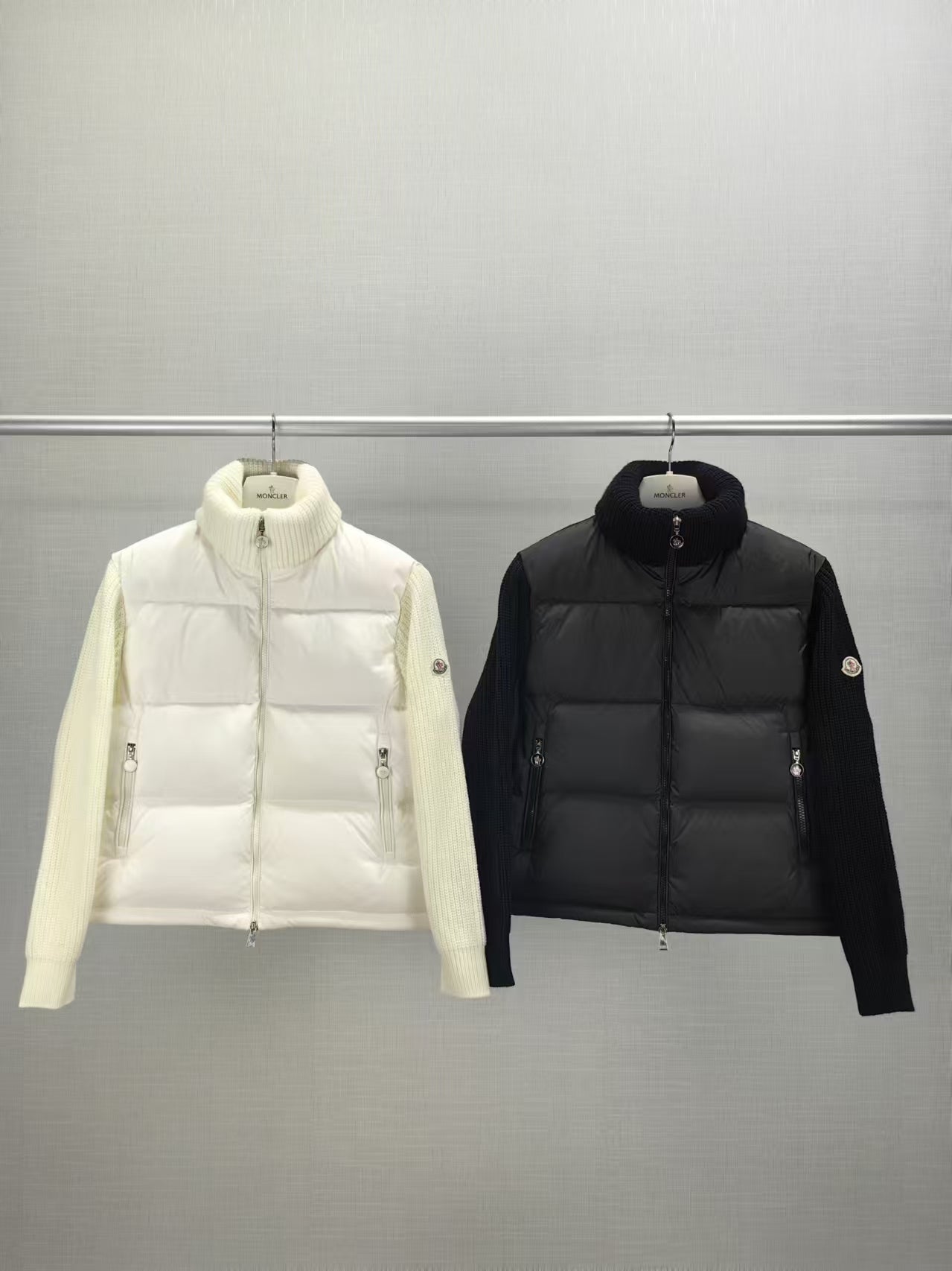 White and black long puffer jackets, zip-front with stand collar, side view