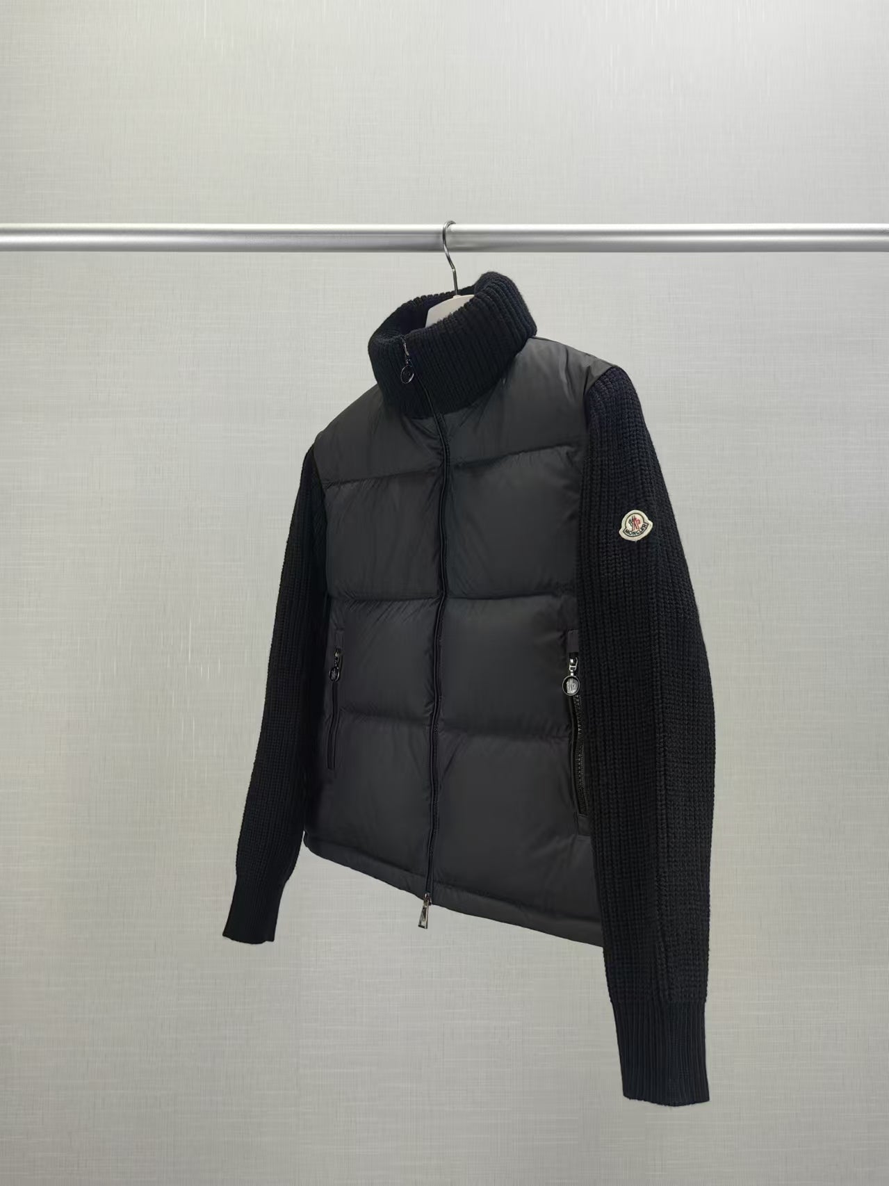 Long puffer jacket side view with knit sleeves, dark collar, front zip closure