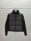 Long puffer jacket with knit sleeves, dark collar, front zip closure and pocket zips
