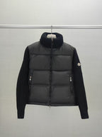 Long puffer jacket with knit sleeves, dark collar, front zip closure and pocket zips