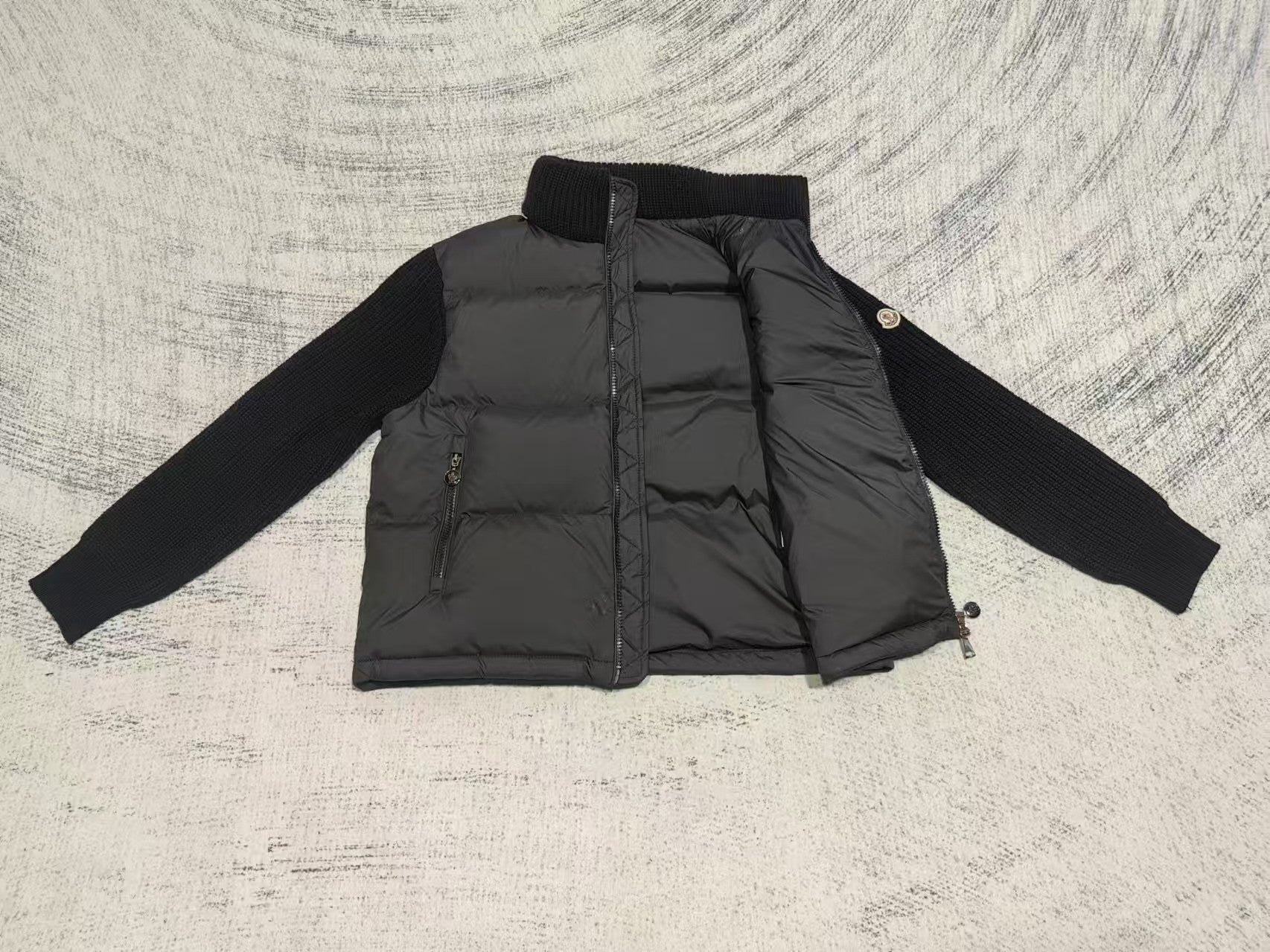 Long puffer jacket front view with stand collar, quilted panels, zipper and pocket zips