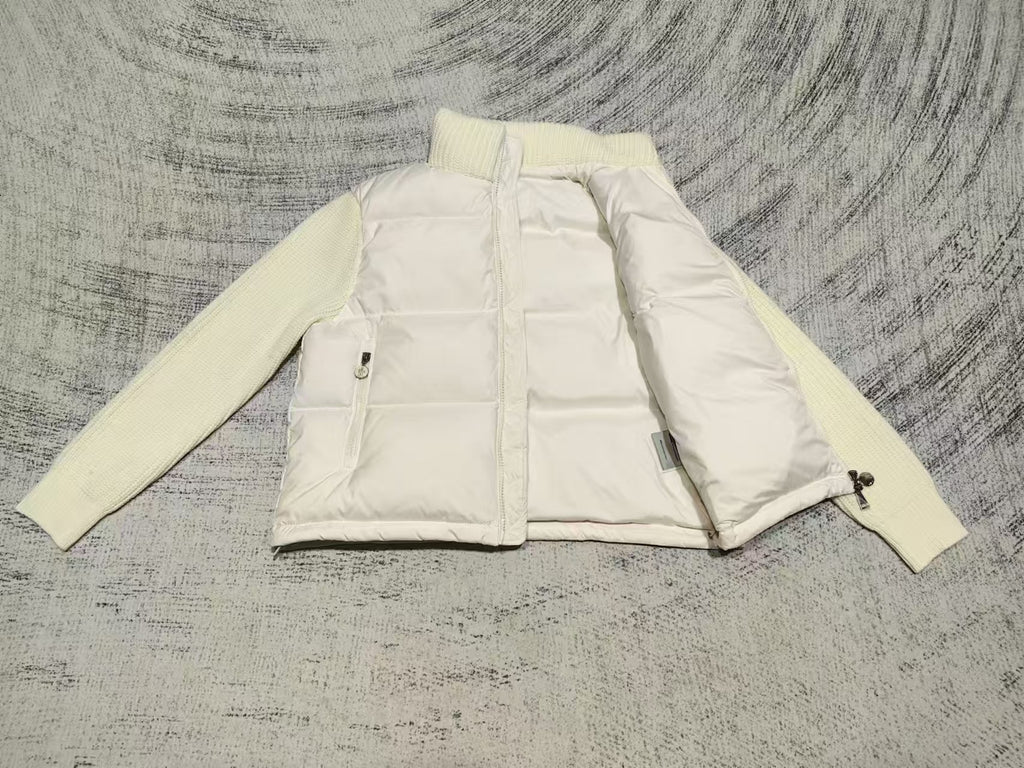 Cream puffer jacket front detail, zip front, pockets, knit sleeves, side view