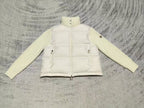 Cream puffer jacket with high neck, zip front, snap pockets, knit cuffs