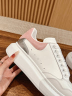 White sneaker with pink suede collar and gray side insert, lace-up