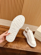 White sneaker outsole with tread and lace-up upper