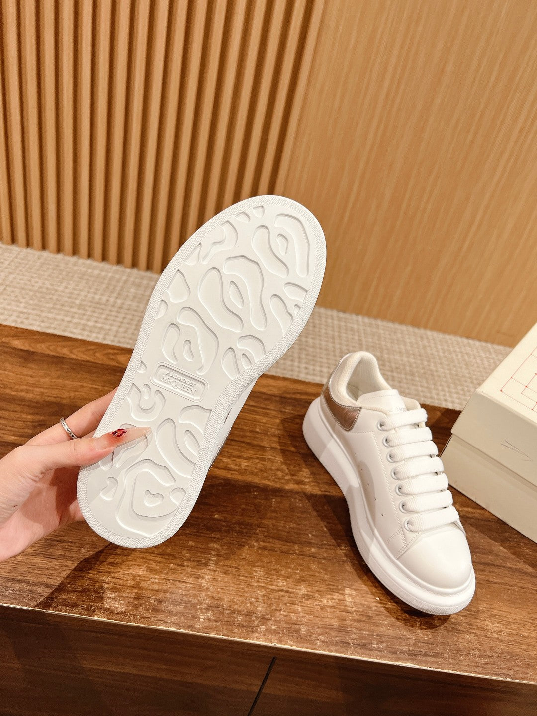 White sneaker outsole with tread and lace-up upper