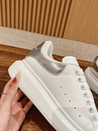 White low-top sneakers with silver glitter heel panel and lace-up front