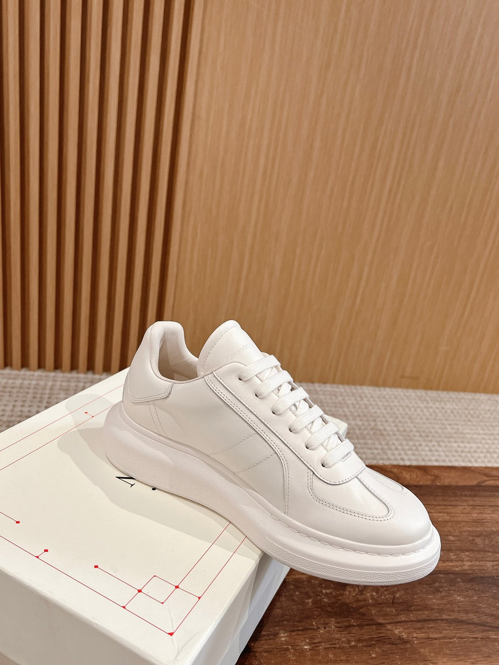 White leather lace-up sneakers with low sole and minimal stripe stitching