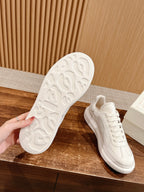 White sneaker outsole with textured tread, paired with lace-up upper