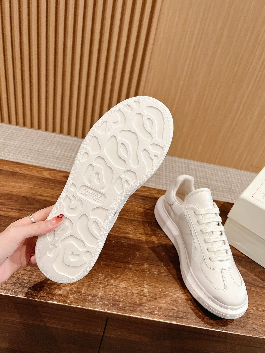 White sneaker outsole with textured tread, paired with lace-up upper