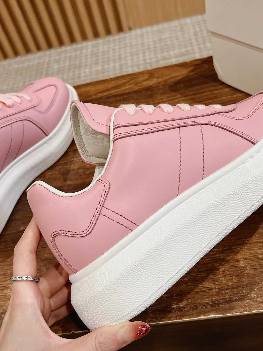 Pink Alexander McQueen sneakers, side panel detail with white rubber sole