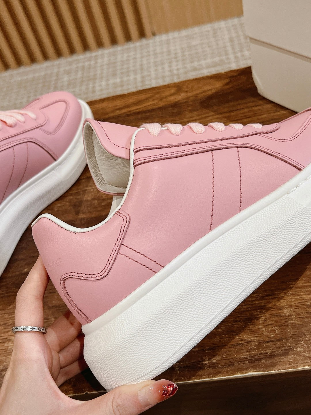 Pink Alexander McQueen sneakers, side panel detail with white rubber sole